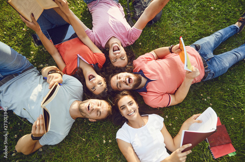 Young people are laughing while lying on the grass photo