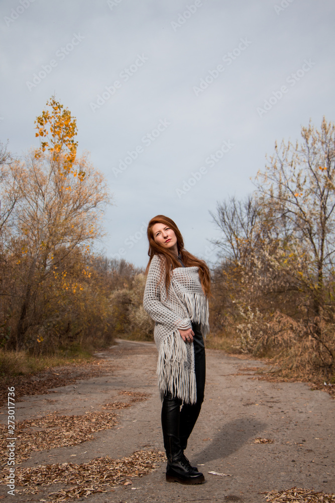 Young redhead woman with scarf in autumn park Young redhead woman with scarf in autumn park