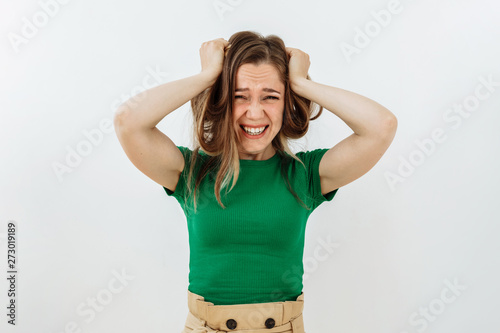 Frustrated and stress emotion. Portrait of brown hairl young woman against white background