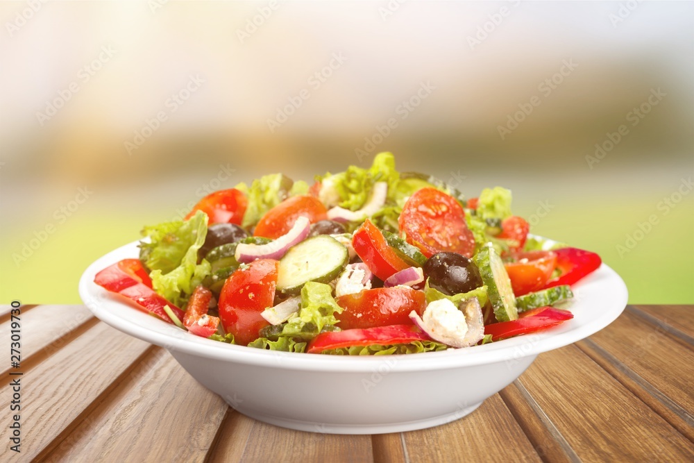 Close-up photo of fresh salad with vegetables in white plate Close-up photo of fresh salad with vegetables in white plate
