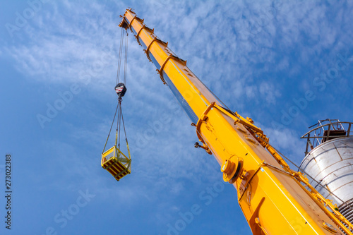 Crane is lifting work basket photo