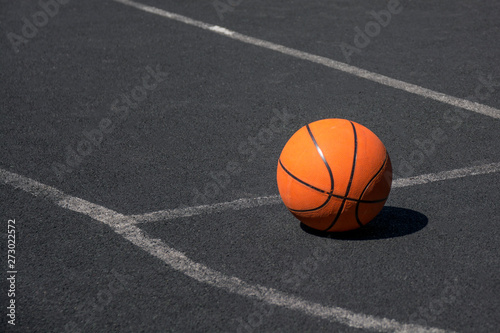 Orange basketball on the black playground. Basketball ball