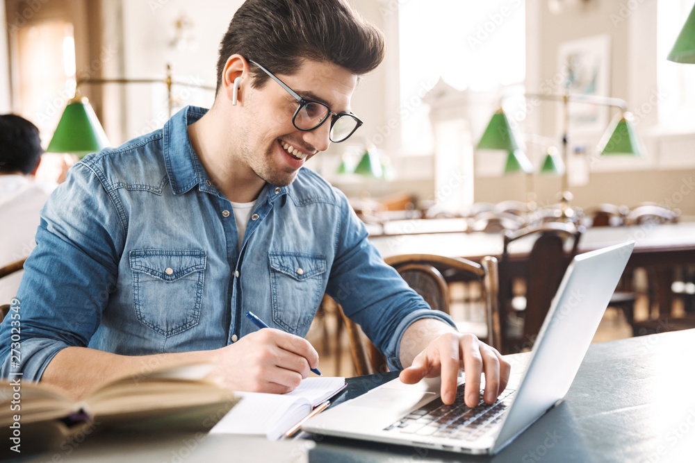 Fotografie Smiling male student studying