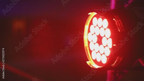 Nightclub LED spotlights glowing with different colored lights, moving in different directions..color lantern in a nightclub.Lighting device that changes color photo