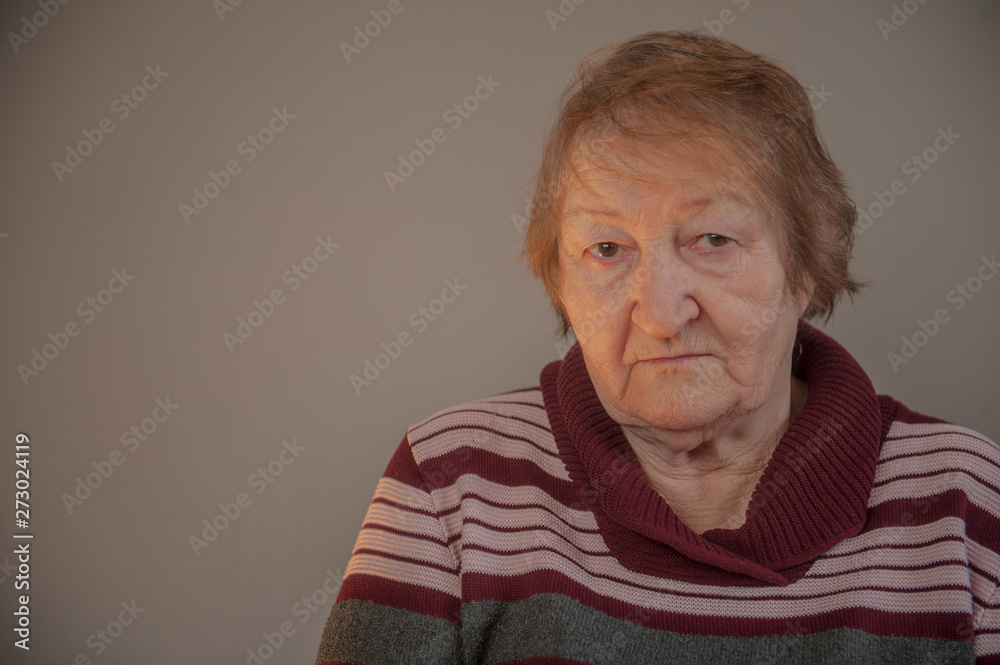 elderly retired woman with hearing impairment received hearing aid of latest modification in center of social protection and tries it on. Help for pensioners and people with disabilities