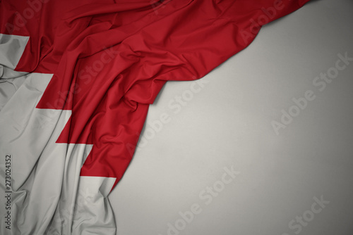 waving national flag of bahrain on a gray background.