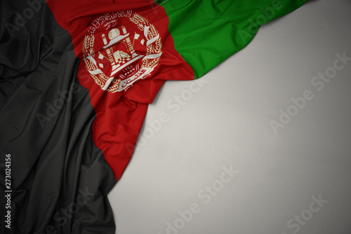 waving national flag of afghanistan on a gray background.