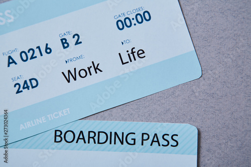 Work life balance choice concept. Boarding pass boarding pass on grey background