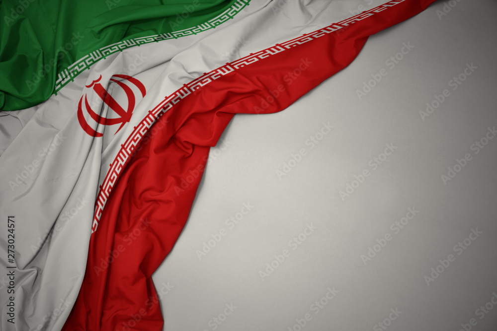 Ταπετσαρία waving national flag of iran on a gray background.