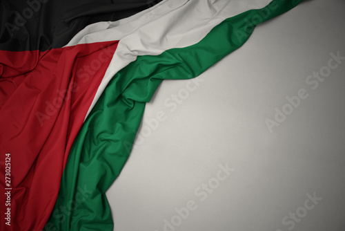 waving national flag of palestine on a gray background. photo