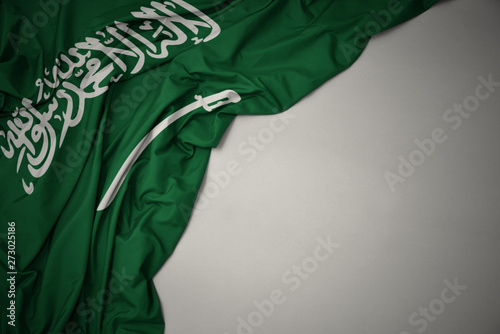 waving national flag of saudi arabia on a gray background. photo