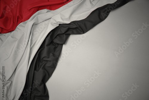 waving national flag of yemen on a gray background. photo