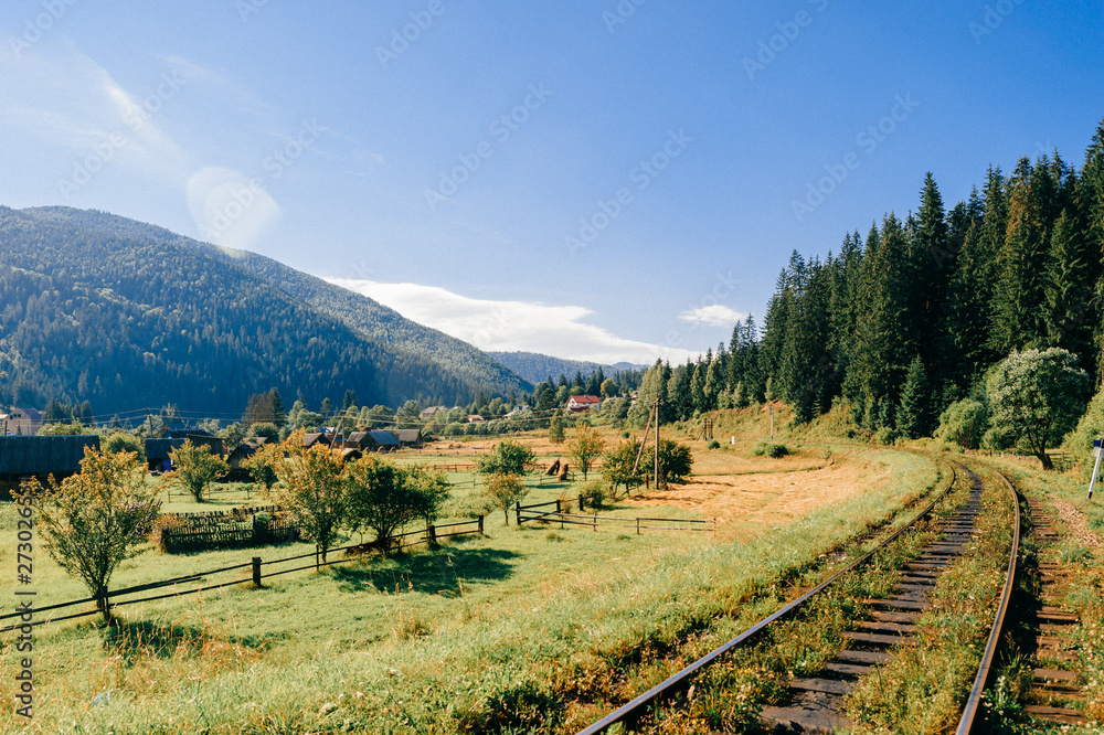 Naklejka premium Rail tracks in the mountains. Railway among beautiful landscape.