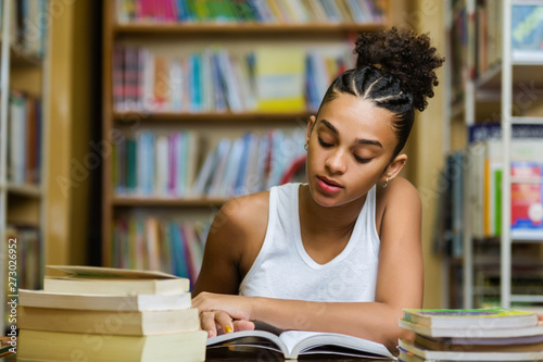 Black african american young girl student studying at the school university library