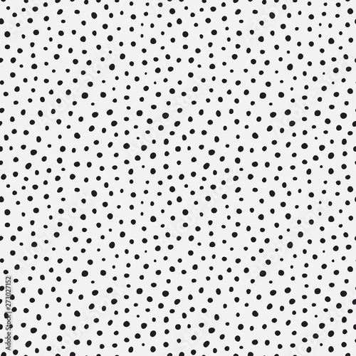 Randomly placed polka dots, hand drawn spots seamless vector pattern. Scattered big and small circles, points in various sizes. Monochrome retro background. Decorative black and white design tiles.