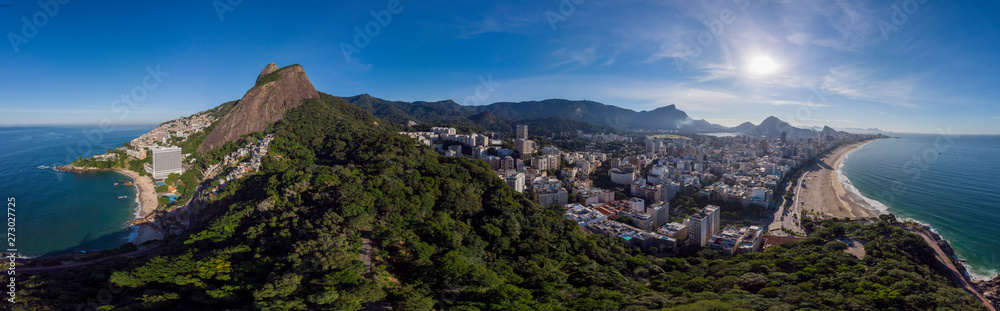 Sunrise 360 degree full panoramic aerial view of Two Brothers mountain and Leblon beach and neighbourhood in Rio de Janeiro in the foreground and the wider cityscape in the background