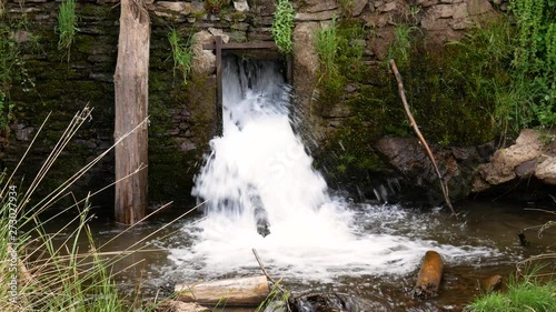 Waterfalls falling down in a lake from a square dam