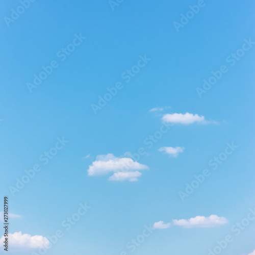 Light cyan blue sky with white clouds