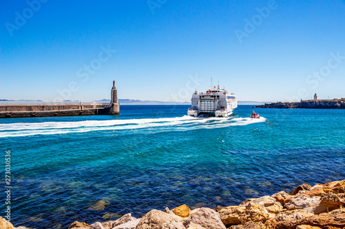 The Maltese Virtu Ferries catamaran Maria Dolores passes by Punta del Santo at the Port of Tarifa, Province of Cadiz, Andalusia Spain