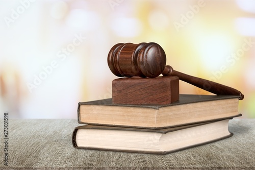 Justice law wooden gavel with stack books on wooden desk