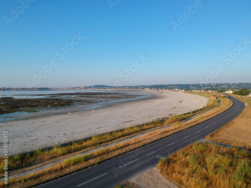 Aerial view of road next to the beach. South coast of Guernsey island, UK, Europe.
