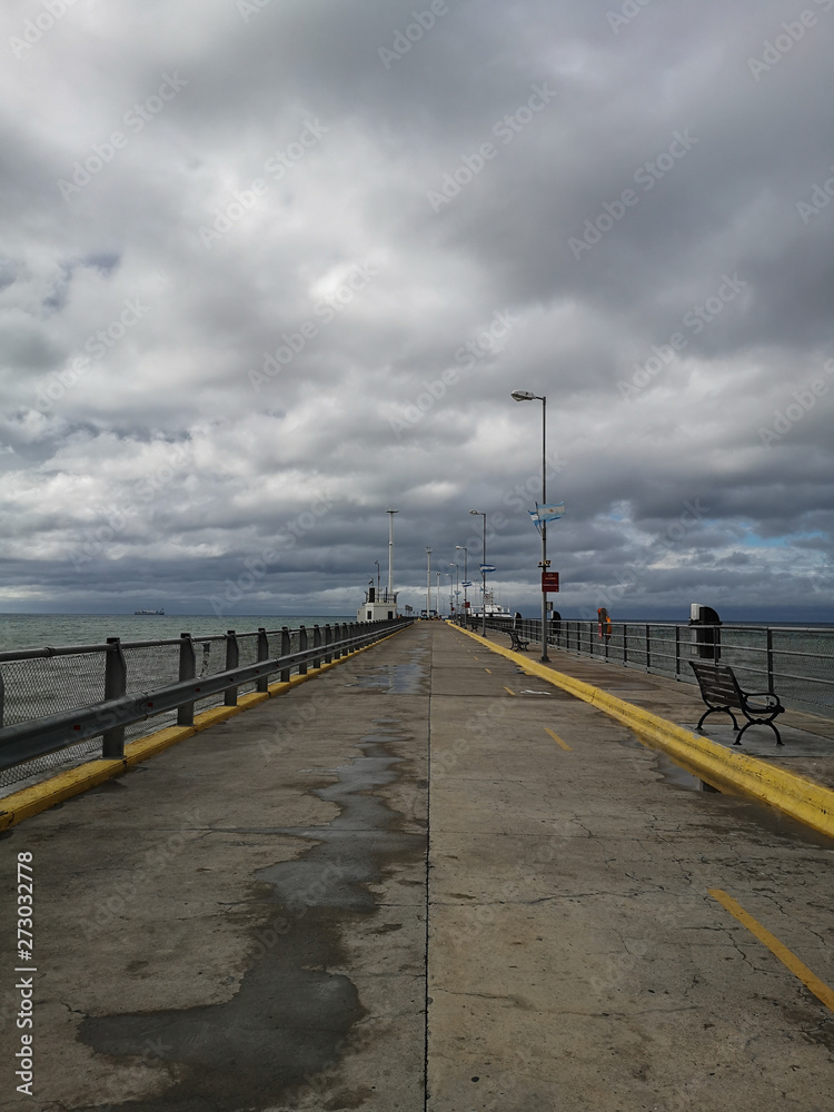 a pier surrounded by dramatic clouds
