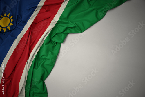 waving national flag of namibia on a gray background. photo