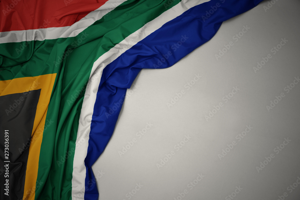 waving national flag of south africa on a gray background. - obrazy, fototapety, plakaty 