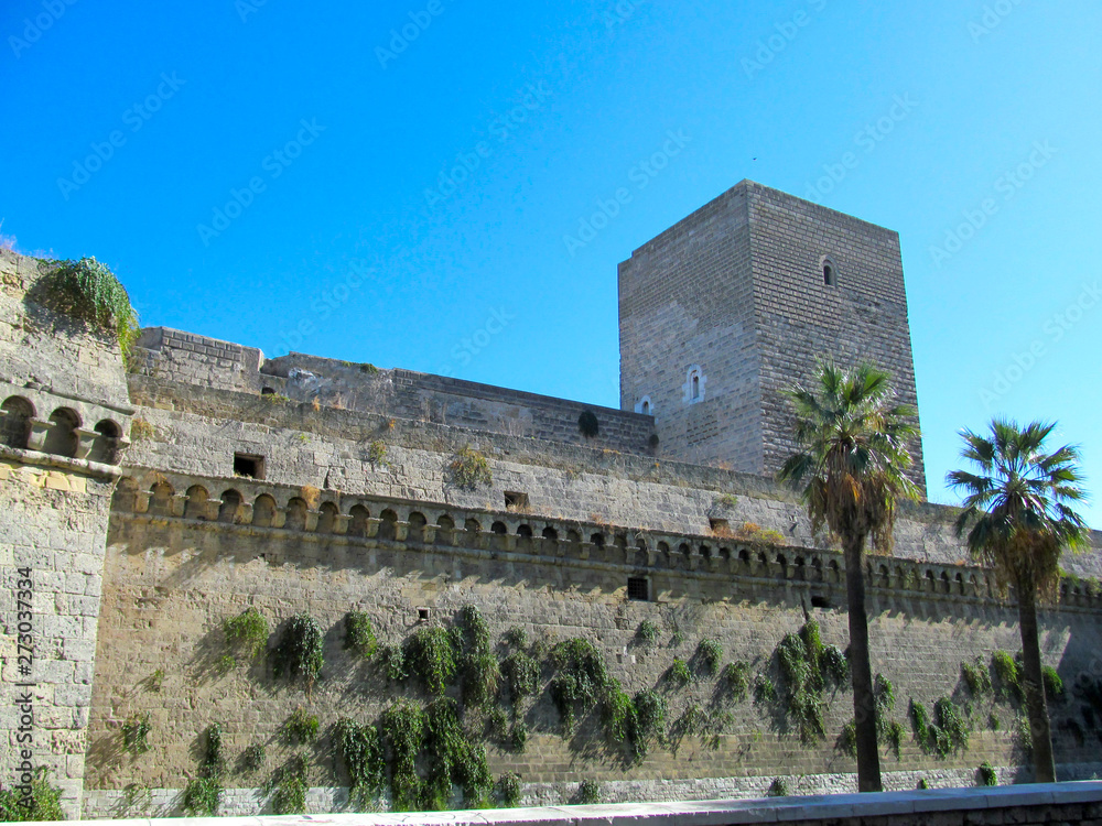 The Norman Castle in Bari, Puglia, Italy. Italian name - Castello Normanno-Svevo. View of the medieval stone wall from the free area.