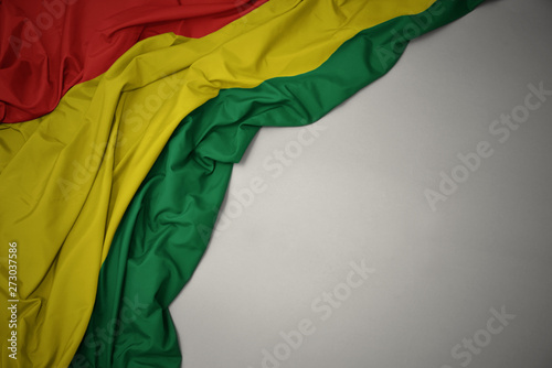 waving national flag of bolivia on a gray background. photo
