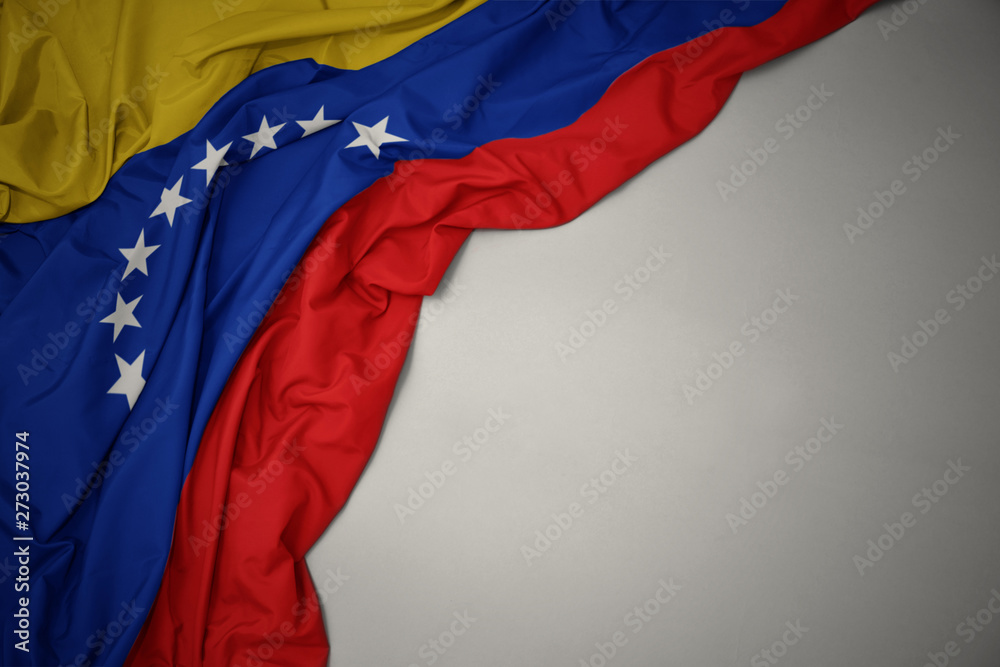 Obraz premium waving national flag of venezuela on a gray background.