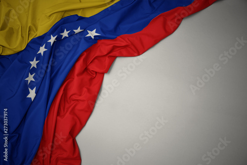 waving national flag of venezuela on a gray background. photo
