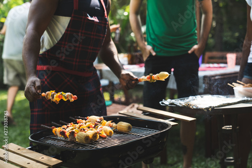 Group of friends at summer outdoor party and holidays concept.