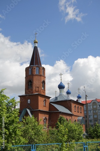 Spring landscape with a view of the church under a blue sky with white clouds in the city of Kanash, Chuvashia photo