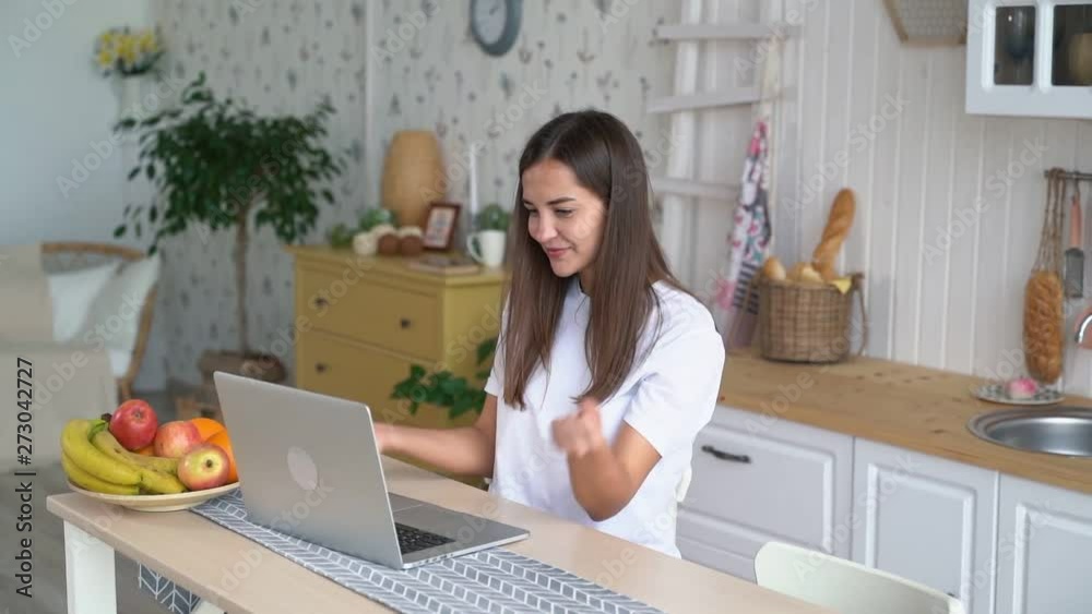Woman works on laptop, gets positive news in email, feels happy, excited, slow motion Woman works on laptop, gets positive news in email, feels happy, excited, slow motion