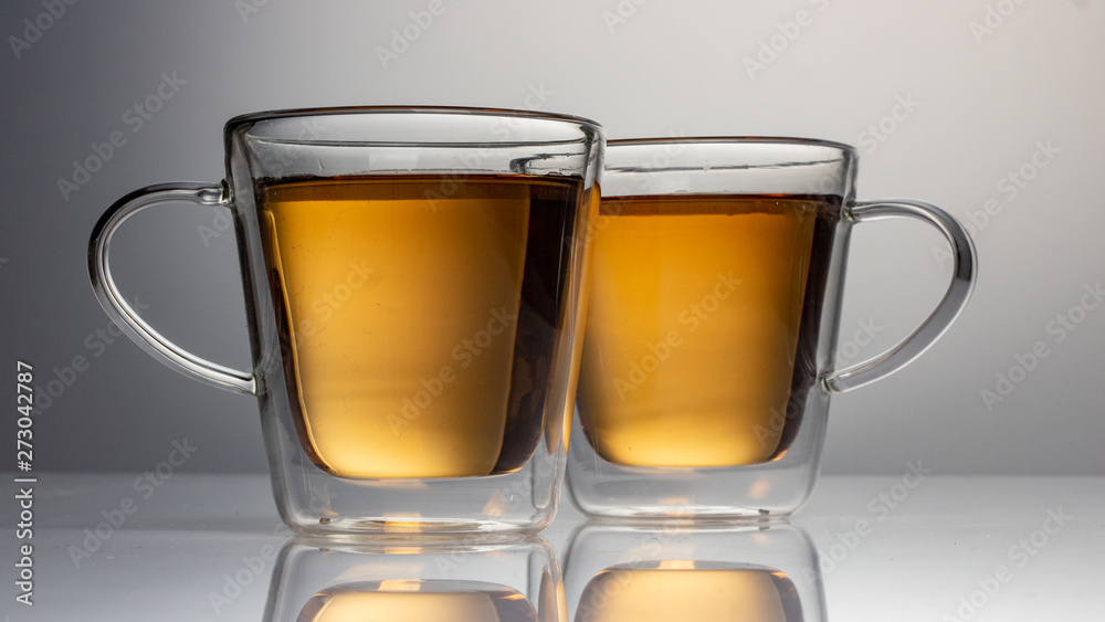 green tea with jasmine in a transparent glass thermomug on a white background green tea with jasmine in a transparent glass thermomug on a white background