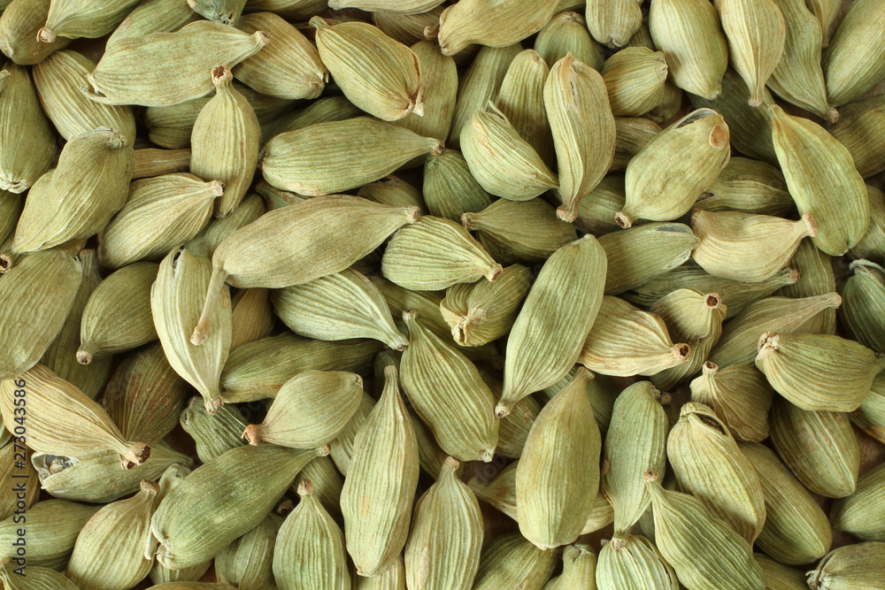 Top view on a pile of dry scattered unrefined cardamom seeds Top view on a pile of dry scattered unrefined cardamom seeds