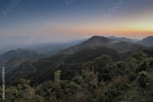 sunset at Doi Ang Khang  Mountain view evening of top hill around with soft fog and yellow sun light in the sky background  Monzone Camping Zone  Doi Angkhang  Chiang Mai  Thailand.
