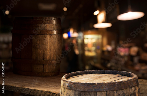 Beer barrel with beer glasses on a wooden table. The dark brown background.