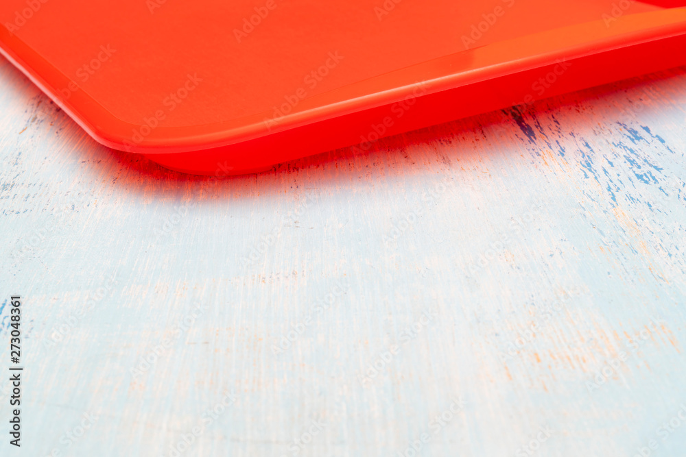 Red plastic dining tray on table. Red plastic dining tray on table.