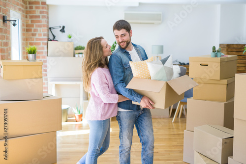 Young beautiful couple very happy together holding cardboard boxes moving to a new home © Krakenimages.com