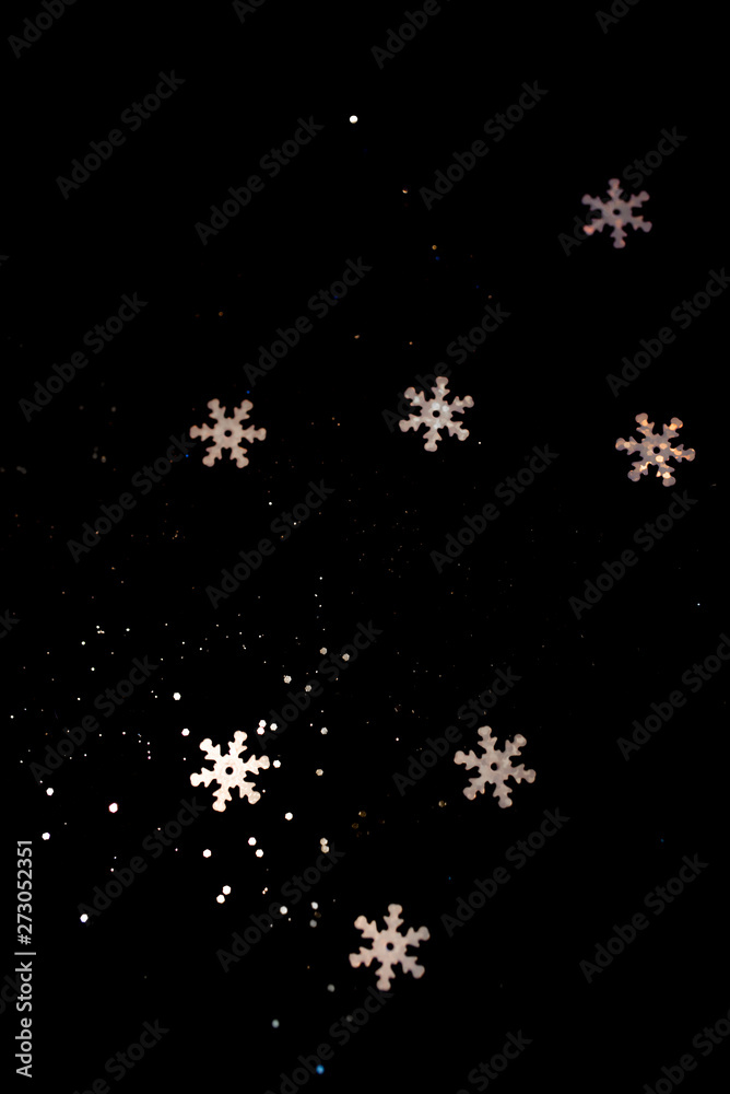 Abstract black background with isolated defocused snowflakes. Abstract black background with isolated defocused snowflakes.