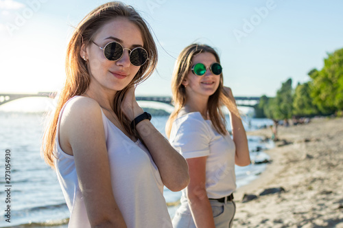 portrait of two young beautiful girls on the beach © Богдан Маліцький