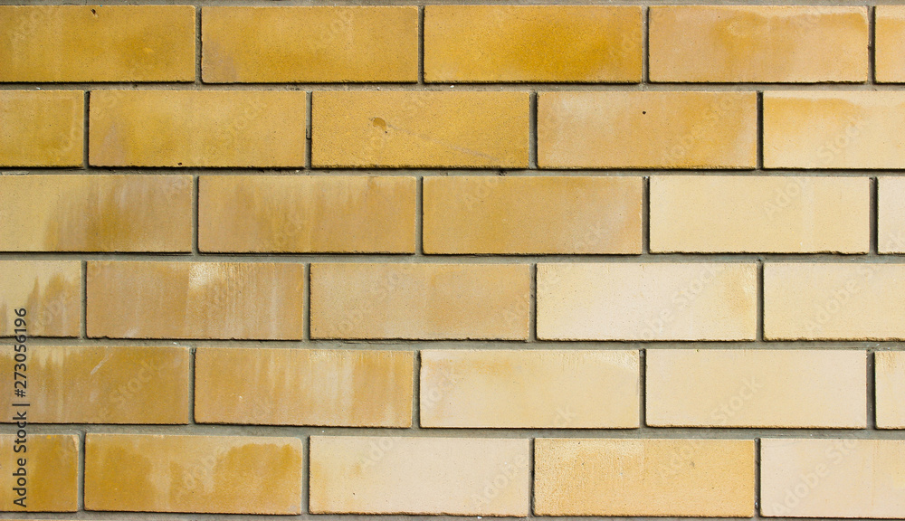 Obraz premium Light brown brickwork. Bricks of different shades of yellow and brown colors.