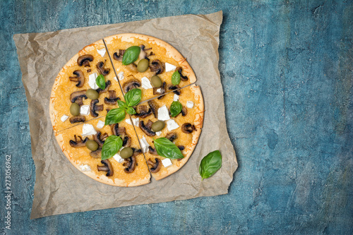 Pizza with mushrooms, cheese, olives and basil