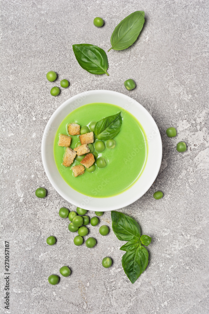 Soup of green peas with basil leaves and croutons Soup of green peas with basil leaves and croutons