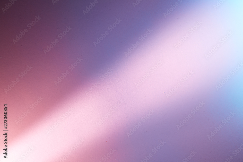 Light pink diagonal blurred ray of light on a pink and purple background