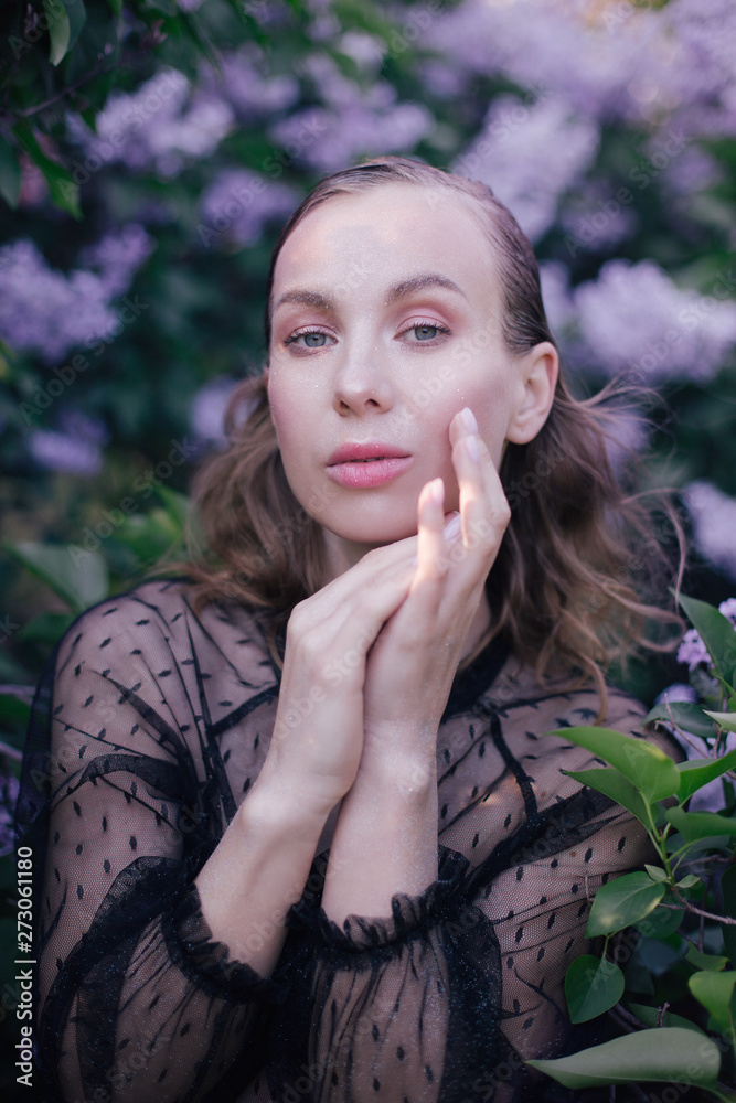 Young beautiful woman with fantasy make up posing with lilac flowers Young beautiful woman with fantasy make up posing with lilac flowers