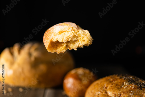 Piece of bread floating on a set of loaves