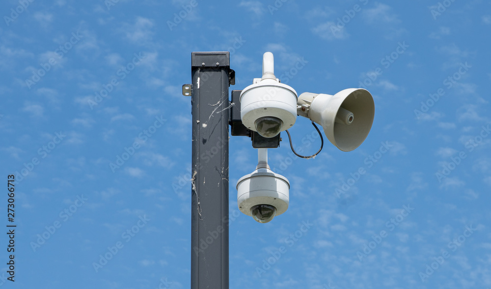 security cameras are mounted high to watch the activity nearby security cameras are mounted high to watch the activity nearby